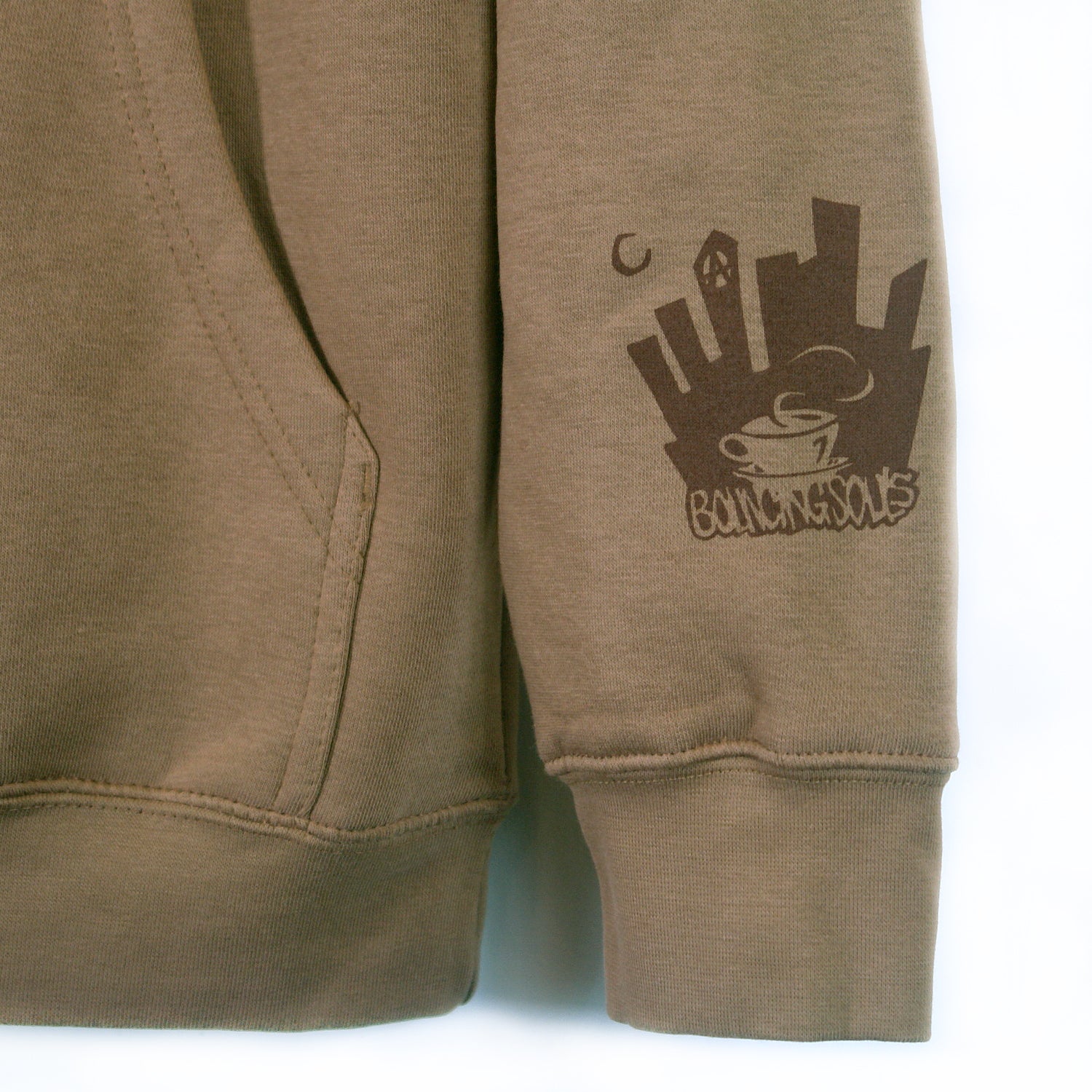 close up image of  small cuff print on the bottom right sleeve of a city scape and says bouncing souls